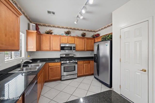 kitchen featuring sink, stainless steel appliances, and light tile patterned floors