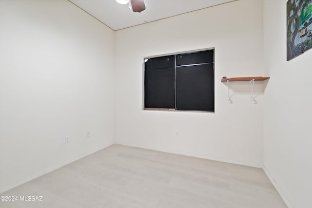 spare room featuring ceiling fan and light hardwood / wood-style floors