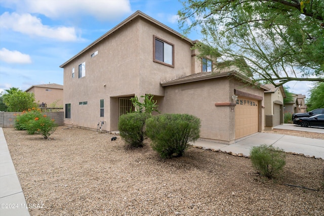 view of side of home featuring a garage