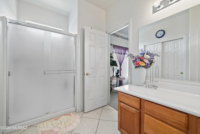 bathroom featuring vanity, tile patterned floors, and walk in shower