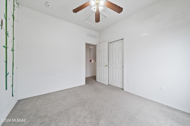 unfurnished bedroom with ceiling fan, light carpet, and a closet