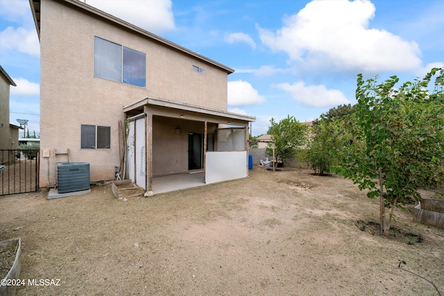 back of property with cooling unit and a patio area