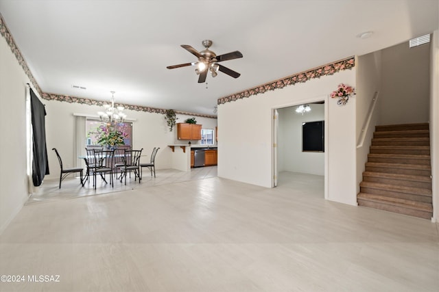 unfurnished dining area featuring ceiling fan with notable chandelier