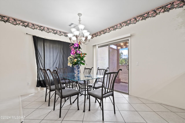 tiled dining space featuring an inviting chandelier