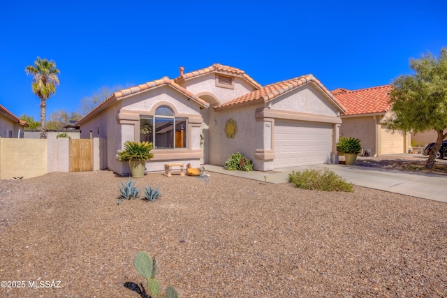 view of front of house with a garage, fence, concrete driveway, a tiled roof, and stucco siding