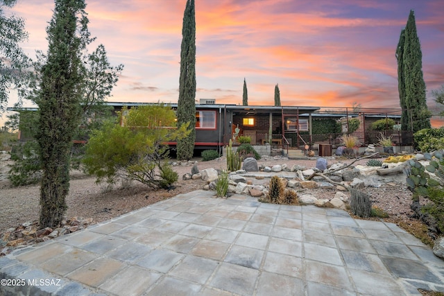 view of front of home featuring covered porch and a patio area