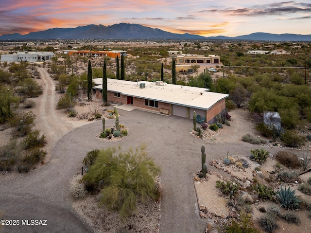 aerial view at dusk featuring a mountain view