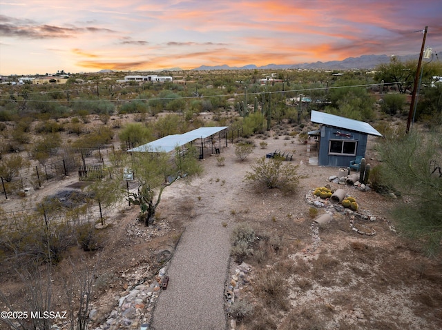 aerial view at dusk featuring a mountain view