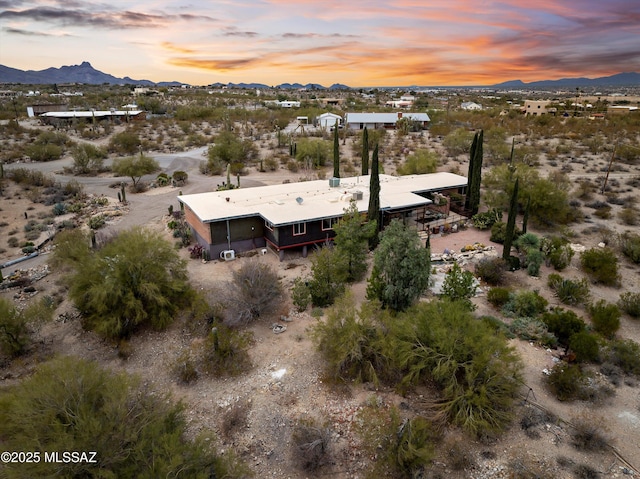 aerial view featuring a desert view and a mountain view