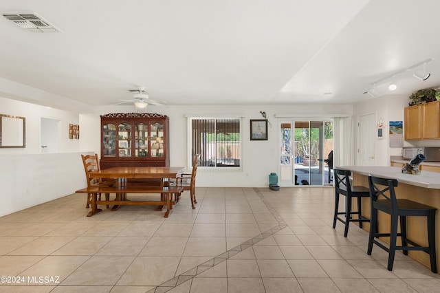 5897 E Cedarbird Dr, Tucson, AZ 85756 - dining area featuring light tile patterned flooring, a ceiling fan, and rail lighting