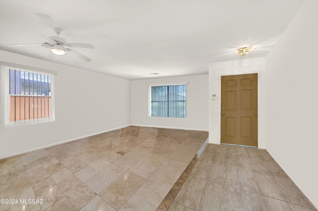 5897 E Cedarbird Dr, Tucson, AZ 85756 - unfurnished room with a ceiling fan and baseboards