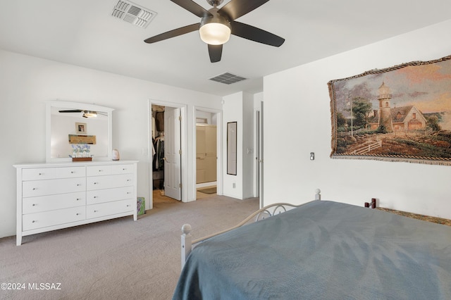5897 E Cedarbird Dr, Tucson, AZ 85756 - bedroom featuring light colored carpet, a spacious closet, a ceiling fan, ensuite bathroom, and a closet