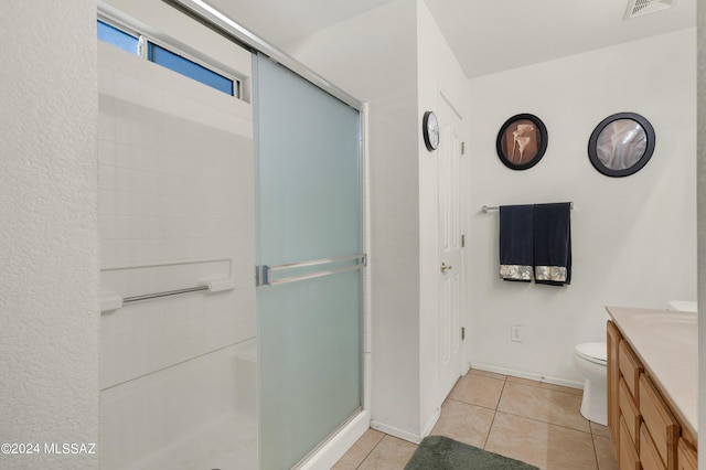5897 E Cedarbird Dr, Tucson, AZ 85756 - bathroom with vanity, an enclosed shower, tile patterned floors, toilet, and baseboards