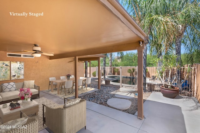 5897 E Cedarbird Dr, Tucson, AZ 85756 - fenced backyard with outdoor lounge area, ceiling fan, a patio area, and outdoor dining area