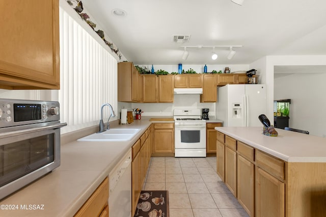5897 E Cedarbird Dr, Tucson, AZ 85756 - kitchen with white appliances, a sink, under cabinet range hood, and light countertops