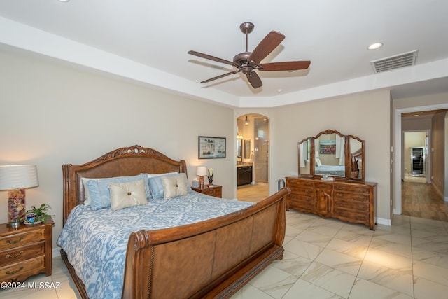 bedroom with ensuite bathroom, visible vents, recessed lighting, arched walkways, and ceiling fan