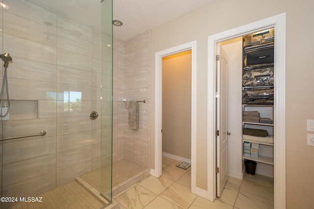 bathroom featuring baseboards, walk in shower, and marble finish floor