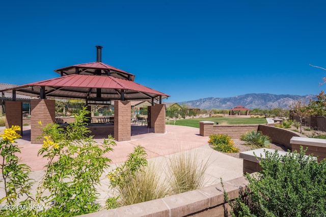 view of patio with a mountain view and a gazebo