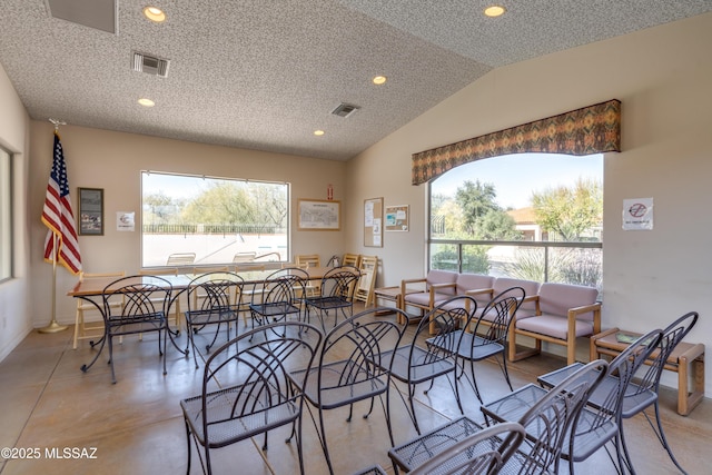 dining space with lofted ceiling, a healthy amount of sunlight, visible vents, and recessed lighting