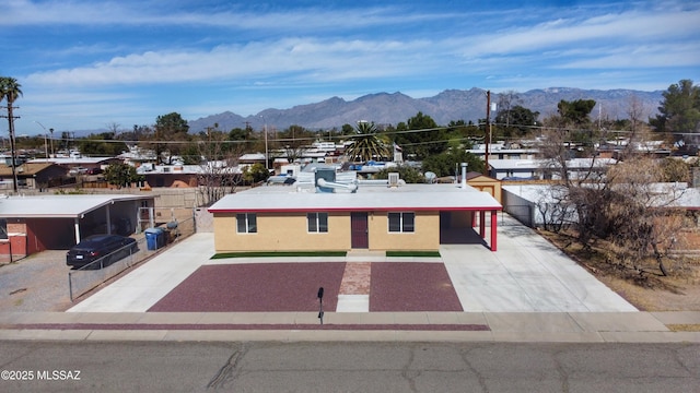 view of front of property featuring driveway, a mountain view, and stucco siding