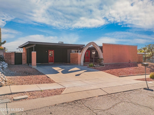 view of front of property with driveway, fence, and an attached carport