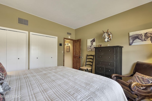 bedroom with visible vents and multiple closets