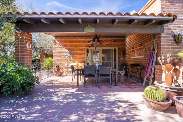 view of patio / terrace with outdoor dining space and fence