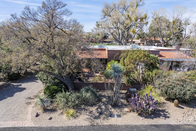 exterior space featuring a tiled roof