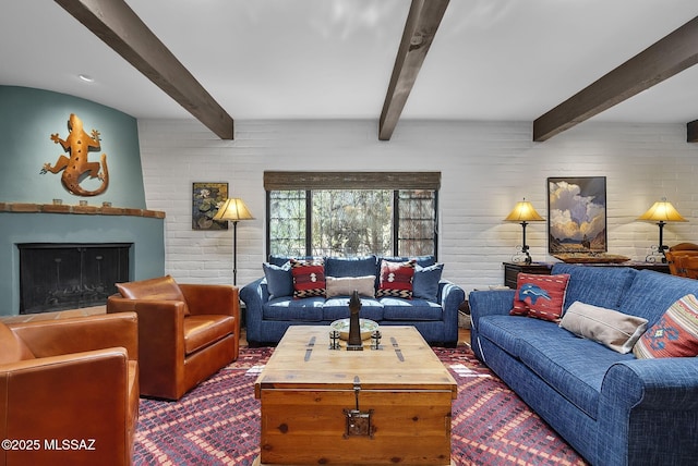 living room with beam ceiling and a fireplace