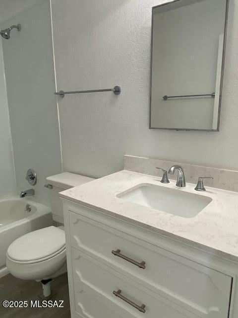 full bath featuring bathing tub / shower combination, vanity, and toilet