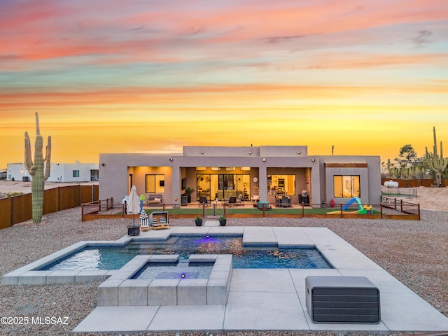 view of pool featuring a fenced in pool, a fenced backyard, a patio, and an in ground hot tub