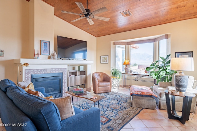 tiled living area with ceiling fan, wooden ceiling, a fireplace, visible vents, and vaulted ceiling