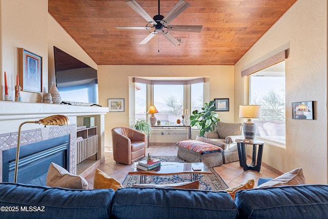 tiled living room featuring vaulted ceiling, wood ceiling, a fireplace, and a ceiling fan