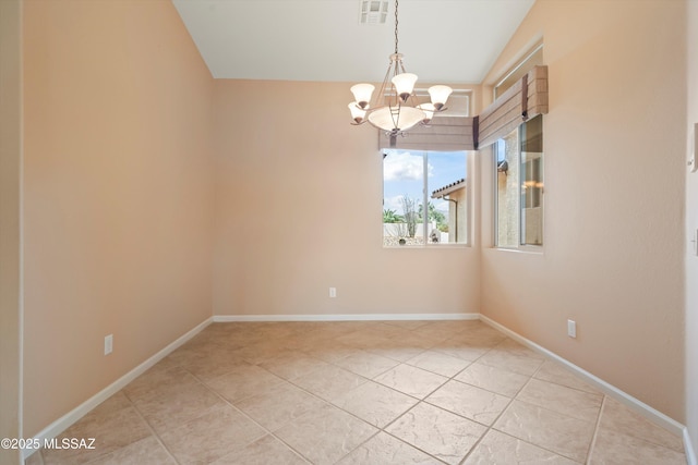 empty room with baseboards, visible vents, and a notable chandelier