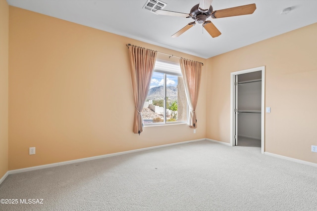 unfurnished bedroom featuring carpet floors, baseboards, visible vents, and ceiling fan