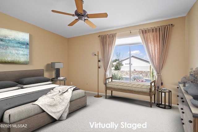 carpeted bedroom with ceiling fan and baseboards