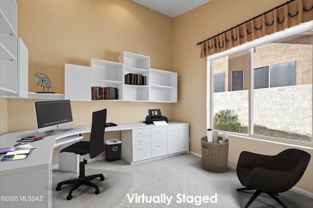 home office featuring light carpet, a wealth of natural light, and baseboards