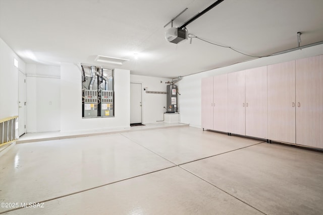 garage featuring water heater and a garage door opener