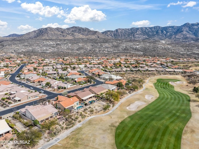 drone / aerial view with a residential view, a mountain view, and golf course view