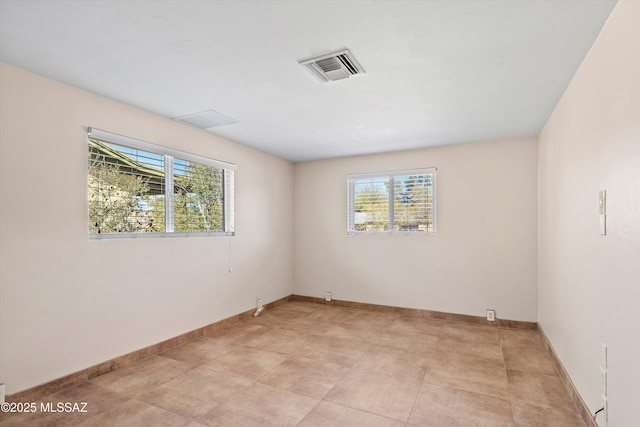 spare room with visible vents and baseboards