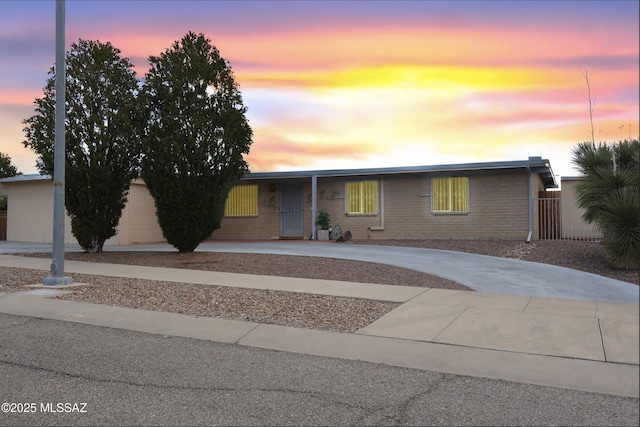 view of front of house featuring fence and driveway