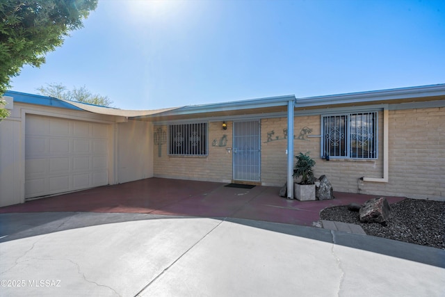 ranch-style house featuring a garage and concrete driveway