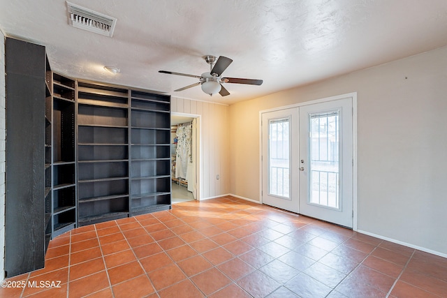 unfurnished room with visible vents, baseboards, ceiling fan, tile patterned floors, and french doors