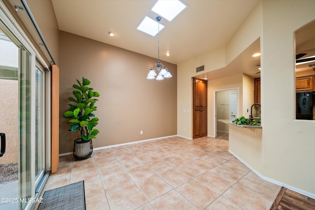 unfurnished room with light tile patterned floors, baseboards, visible vents, and a chandelier