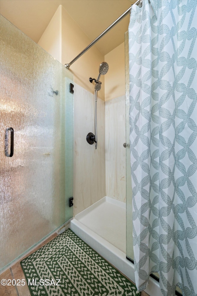 bathroom with tile patterned floors and a stall shower