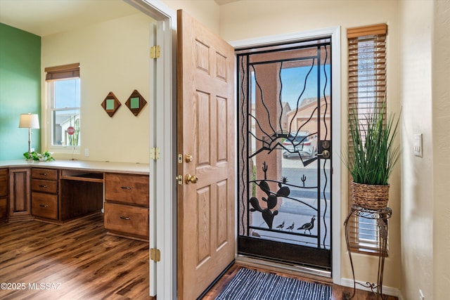entrance foyer with baseboards and dark wood-style floors