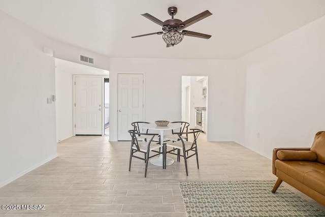 dining space with light wood-style floors, visible vents, and a ceiling fan