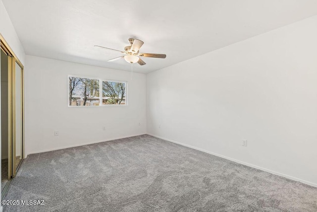 unfurnished bedroom with carpet floors, a closet, ceiling fan, and baseboards