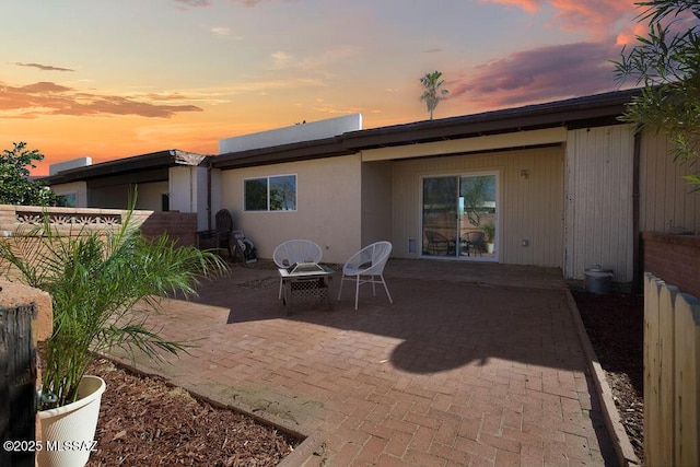 back of property with a patio and fence