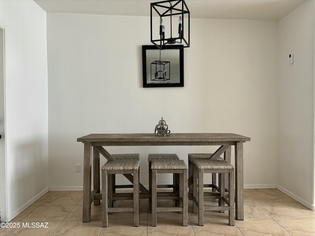 dining area featuring light tile patterned floors and baseboards